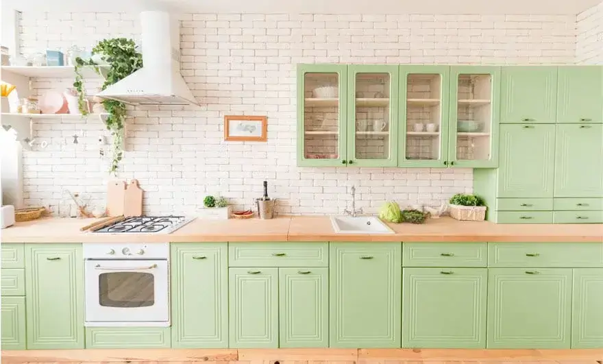 Beautiful green kitchen interior design featuring a straight modular layout with contemporary cabinetry and a vibrant color scheme.